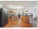 Open kitchen featuring stainless steel appliances, wood cabinets, a center island, and hardwood floors at 701 Fir Chase, Fairburn, GA 30213