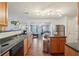 Bright kitchen overlooking the living room, complete with modern appliances, wood cabinets, and dark countertops at 701 Fir Chase, Fairburn, GA 30213