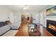 Inviting living room with hardwood floors, a fireplace, a modern couch, and an open layout at 701 Fir Chase, Fairburn, GA 30213
