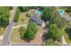 A high aerial view of a home with pool and landscaping surrounded by trees at 12 Blackfoot Trl, Sharpsburg, GA 30277