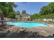 Aerial view of backyard featuring swimming pool, lush landscaping, fence and outdoor seating at 12 Blackfoot Trl, Sharpsburg, GA 30277