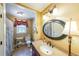 Traditional bathroom with decorative oval mirror, patterned walls, and granite countertop vanity at 12 Blackfoot Trl, Sharpsburg, GA 30277