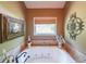 Inviting bathroom featuring a jacuzzi tub, tile surround and decorative art at 12 Blackfoot Trl, Sharpsburg, GA 30277