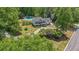 Home with large front yard, landscaping, long driveway, and charming facade at 12 Blackfoot Trl, Sharpsburg, GA 30277