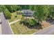 Exterior view of home and a lush front yard with trees in a neighborhood setting at 12 Blackfoot Trl, Sharpsburg, GA 30277