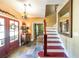 Inviting foyer with tiled floor, wooden staircase, and decorative accents, creating a warm entrance at 12 Blackfoot Trl, Sharpsburg, GA 30277
