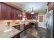 Well-equipped kitchen with dark wood cabinets, granite countertops, and stainless steel appliances at 12 Blackfoot Trl, Sharpsburg, GA 30277
