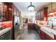 Modern kitchen featuring dark wood cabinets, granite countertops, and stainless steel appliances at 12 Blackfoot Trl, Sharpsburg, GA 30277