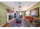Cozy living room with fireplace, hardwood floors, and comfortable seating, ideal for relaxation at 12 Blackfoot Trl, Sharpsburg, GA 30277
