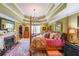 Comfortable bedroom with four-poster bed, fireplace, rug and decorative trey ceiling at 12 Blackfoot Trl, Sharpsburg, GA 30277