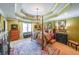 Comfortable main bedroom suite with four-poster bed, sitting area and trey ceiling detail at 12 Blackfoot Trl, Sharpsburg, GA 30277