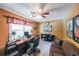 Inviting home office with a large desk, comfortable seating, and ample natural light at 12 Blackfoot Trl, Sharpsburg, GA 30277