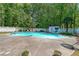 Backyard in-ground pool surrounded by a concrete deck, lounge chairs and privacy fence at 12 Blackfoot Trl, Sharpsburg, GA 30277