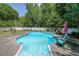 Backyard swimming pool featuring a concrete surround, lounge chairs, and slide feature at 12 Blackfoot Trl, Sharpsburg, GA 30277