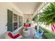 Relaxing front porch area with comfortable seating and hanging ferns, perfect for enjoying the outdoors at 12 Blackfoot Trl, Sharpsburg, GA 30277
