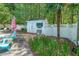 Backyard shed situated near the pool, a privacy fence, and a small palm tree at 12 Blackfoot Trl, Sharpsburg, GA 30277