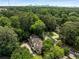 Aerial view highlights home nestled among trees with nearby roads and a distant city skyline at 1341 Sheffield Glen Ne Way, Atlanta, GA 30329