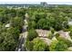 An aerial view of a townhome surrounded by trees, with city views from surrounding neighborhood at 1341 Sheffield Glen Ne Way, Atlanta, GA 30329