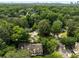 Aerial view showcases the home's location surrounded by lush greenery and a cityscape backdrop at 1341 Sheffield Glen Ne Way, Atlanta, GA 30329