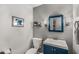 Charming powder room featuring blue vanity, mirror, and modern fixtures at 1341 Sheffield Glen Ne Way, Atlanta, GA 30329