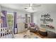A delightful Bedroom featuring a glider, changing table, and natural light from two windows at 1341 Sheffield Glen Ne Way, Atlanta, GA 30329