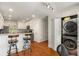 Functional kitchen with breakfast bar and stainless steel washer/dryer combo in a closet at 1341 Sheffield Glen Ne Way, Atlanta, GA 30329