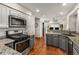 Spacious kitchen with stainless steel appliances, granite counters, and hardwood floors at 1341 Sheffield Glen Ne Way, Atlanta, GA 30329