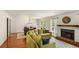 Inviting living room with a fireplace, and a large comfortable-looking yellow couch at 1341 Sheffield Glen Ne Way, Atlanta, GA 30329