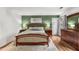 Bright bedroom featuring wood floors, designer accent wall, and outdoor access at 1341 Sheffield Glen Ne Way, Atlanta, GA 30329