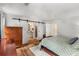 Charming primary bedroom features ensuite bathroom with rustic barn doors at 1341 Sheffield Glen Ne Way, Atlanta, GA 30329