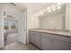 Bathroom features double vanity sinks, granite countertops, and doorway to bedroom at 3075 Westpoint Cir, Snellville, GA 30078