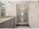 Bathroom features granite countertops, double vanity sinks, glass shower and tile at 3075 Westpoint Cir, Snellville, GA 30078