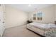 Comfortable bedroom featuring soft carpet, natural light, and a large closet for ample storage at 3075 Westpoint Cir, Snellville, GA 30078