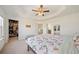 Spacious bedroom boasts tray ceilings, fan, neutral colors, ensuite bathroom, and walk-in closet at 3075 Westpoint Cir, Snellville, GA 30078