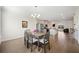 Dining room with hardwood floors flows into the open concept kitchen and living spaces at 3075 Westpoint Cir, Snellville, GA 30078