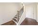 Bright entryway with hardwood floors, stairs with metal railings, and a white front door at 3075 Westpoint Cir, Snellville, GA 30078