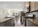 Open concept kitchen with granite countertops, stainless appliances, and hardwood flooring at 3075 Westpoint Cir, Snellville, GA 30078