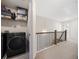 Upstairs laundry area featuring modern washer and dryer units, and wire shelving at 3075 Westpoint Cir, Snellville, GA 30078