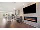 Open floor plan with living room fireplace, kitchen island, dining area and hardwood floors at 3075 Westpoint Cir, Snellville, GA 30078