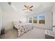 A spacious main bedroom featuring a tray ceiling, large windows, and neutral walls at 3075 Westpoint Cir, Snellville, GA 30078