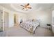 A spacious main bedroom featuring a tray ceiling, ensuite bathroom, and neutral walls at 3075 Westpoint Cir, Snellville, GA 30078