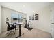Bright home office with a standing desk, ergonomic chair, exercise bike, and natural light streaming in through the window at 3075 Westpoint Cir, Snellville, GA 30078