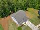 Aerial view of a home showcasing its backyard, roof, and surrounding landscape at 33 New Kent Ct, Villa Rica, GA 30180