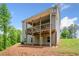 Exterior view of the back of the house with a covered patio, backyard, and landscaping at 33 New Kent Ct, Villa Rica, GA 30180