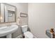 Powder room with a pedestal sink, toilet, and stylish decor at 33 New Kent Ct, Villa Rica, GA 30180