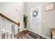 Bright foyer featuring wood floors, white trim, and a decorative glass door with wreath at 33 New Kent Ct, Villa Rica, GA 30180