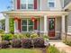 Inviting front porch with white rocking chairs and seasonal floral arrangements at 33 New Kent Ct, Villa Rica, GA 30180