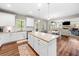 Bright kitchen features an island with granite countertops and opens to the living room at 33 New Kent Ct, Villa Rica, GA 30180
