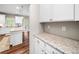 Well-lit kitchen featuring white cabinetry, granite countertops, and stainless steel appliances at 33 New Kent Ct, Villa Rica, GA 30180