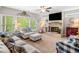 Spacious living room with a brick fireplace, large windows, and a ceiling fan at 33 New Kent Ct, Villa Rica, GA 30180